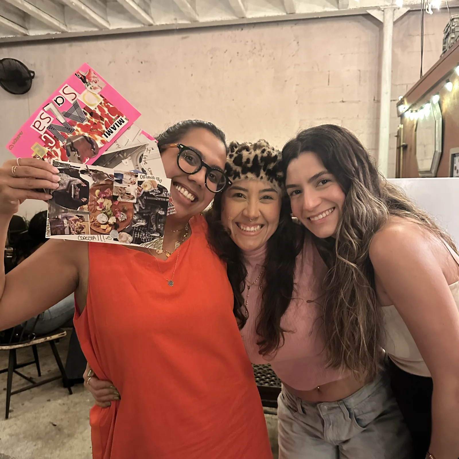 Three panas holding up zines made at a How to Make a Pana Zine pop-up